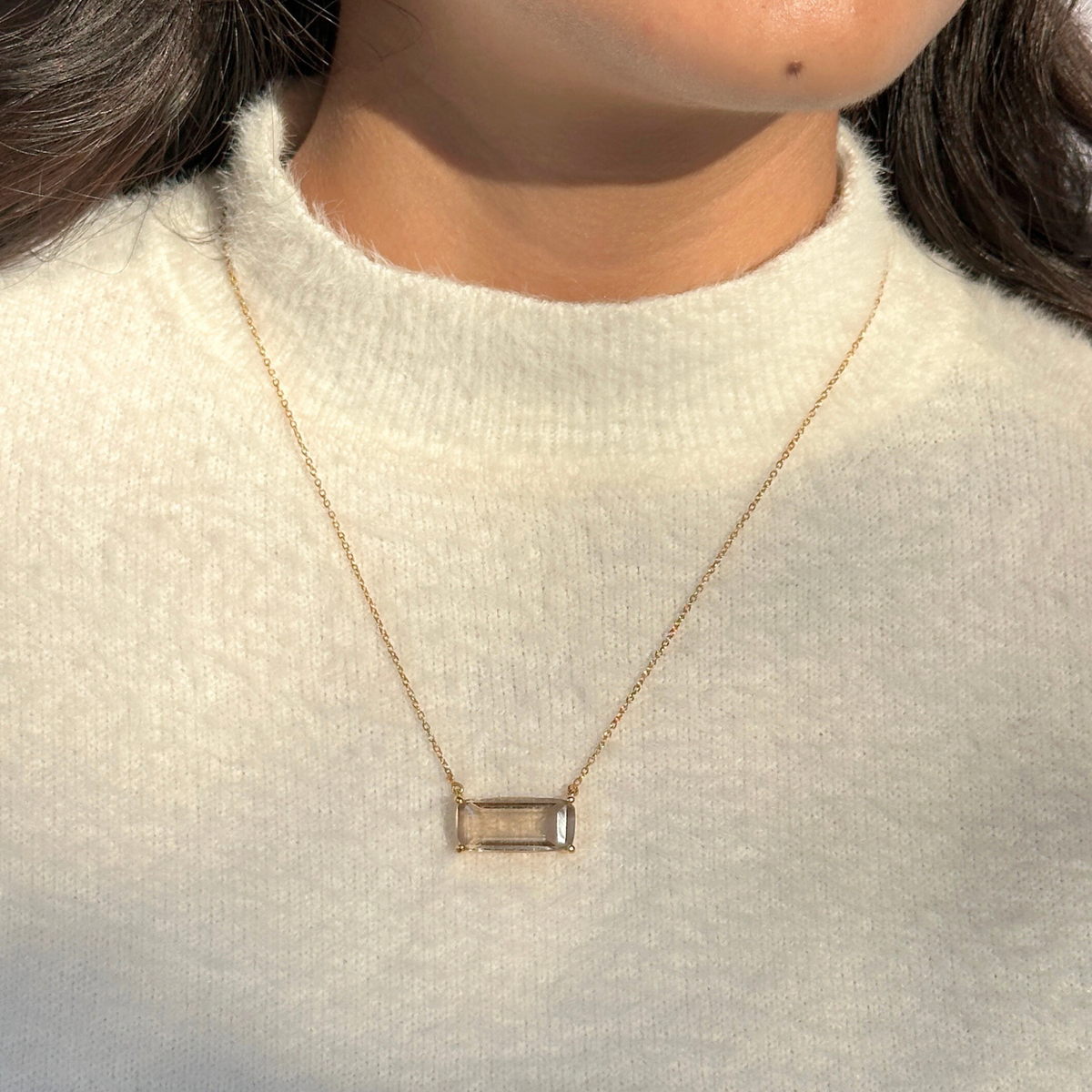 Smokey quartz silver 925 pendant necklace
Natural smokey quartz gemstone silver necklace
Smokey quartz 925 sterling silver pendant
Smokey quartz stone silver necklace India
Elegant smokey quartz silver necklace online
Necklace with a rectangular pendant worn by a person in a white sweater.