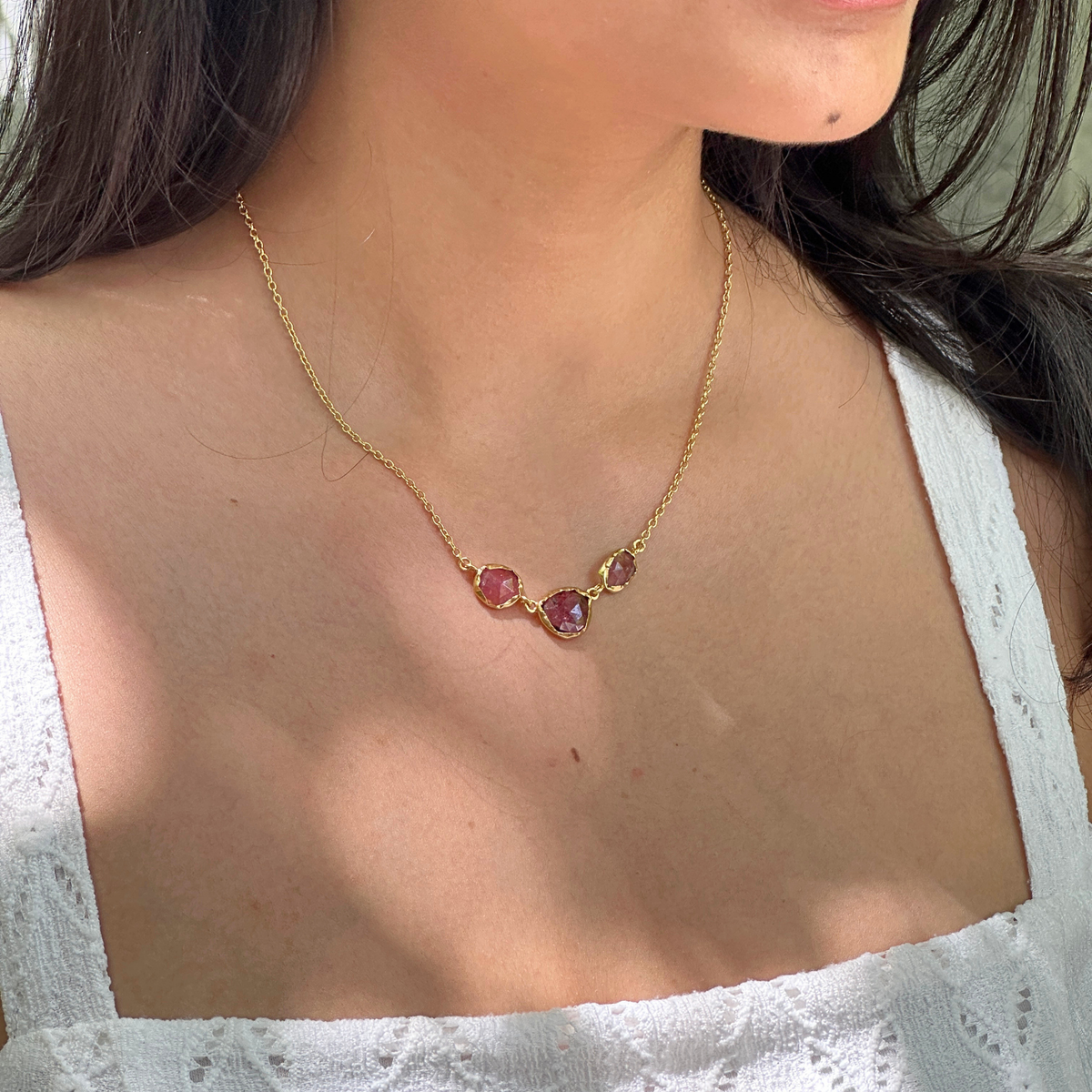 Woman wearing natural pink tourmaline baguette bar necklace 18K gold plated
925 sterling silver minimal jewellery India