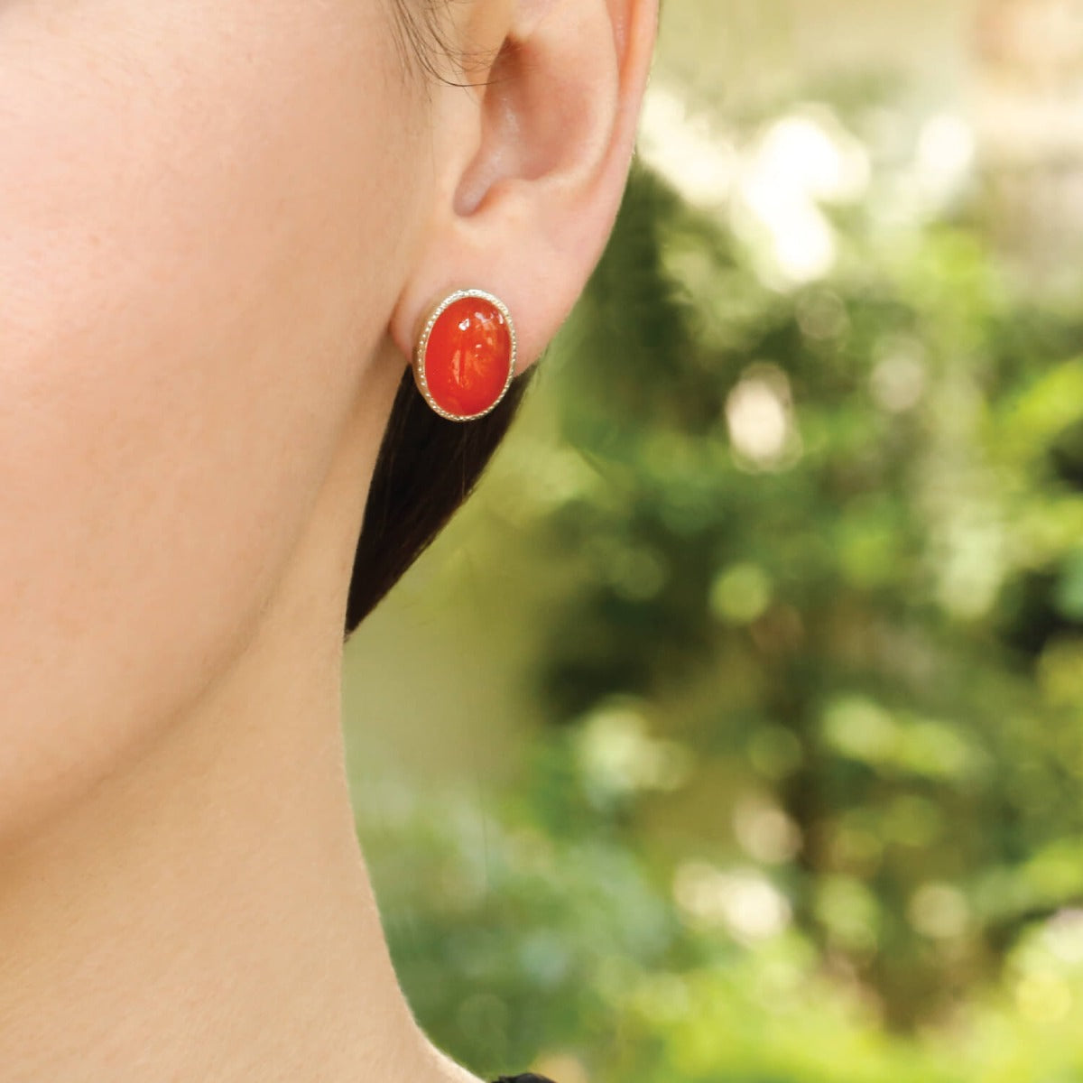 carnelian stud earrings silver 925 worn on ear natural light