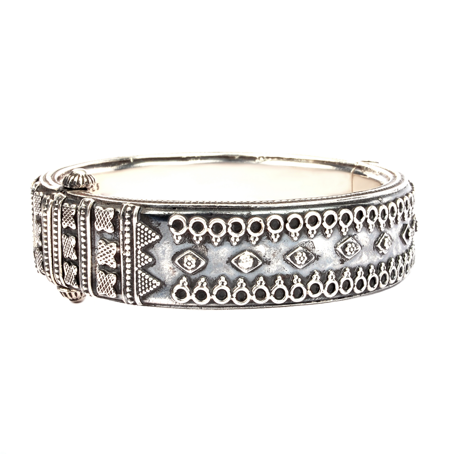 Thick oxidised silver bangle with tribal embossed motifs