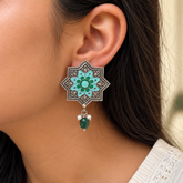 Model wearing oxidised 925 silver star earrings with blue enamel