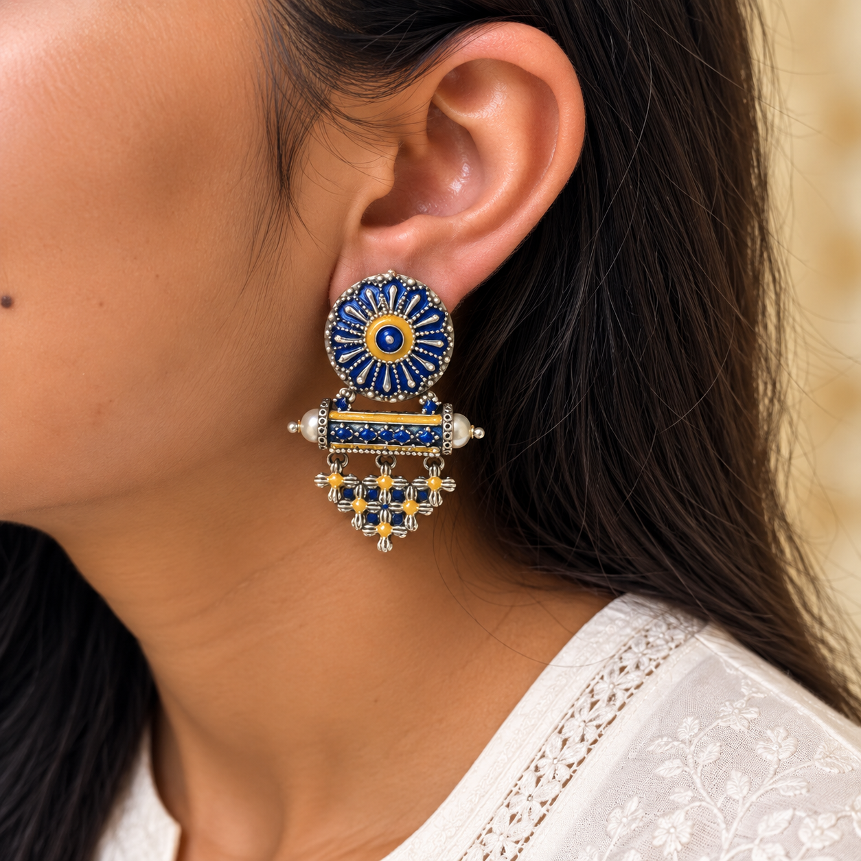 Model wearing oxidised 925 silver blue enamel lattice drop earrings