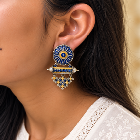 Model wearing oxidised 925 silver blue enamel lattice drop earrings