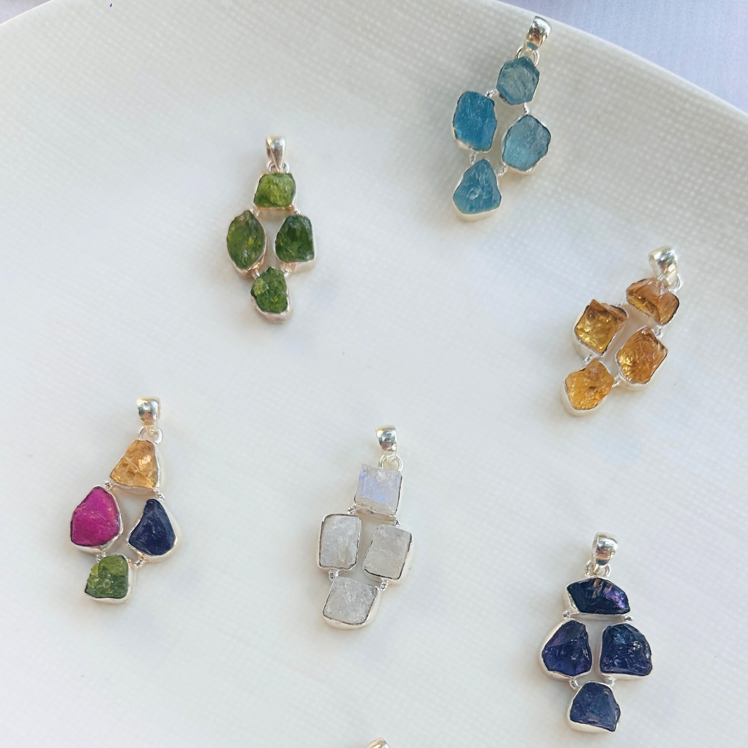 Minimal Pendants
Colorful Pendants
Gemstone Pendant
Peridot Pendant
Aquamarine Pendant
Citrine Pendant
Rainbow Moonstone Pendant
Amethyst Pendant
Minimal silver pendant
Green pendant
Blue pendant
yellow pendant
White pendant
Multicolor pendant
Pendant for women
Gifts for women
Silver pendant 925

Collection of colorful gemstone pendants on a white surface