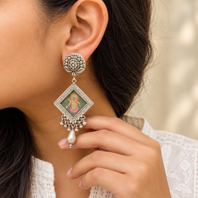 Model wearing 925 silver hand painted Krishna earrings