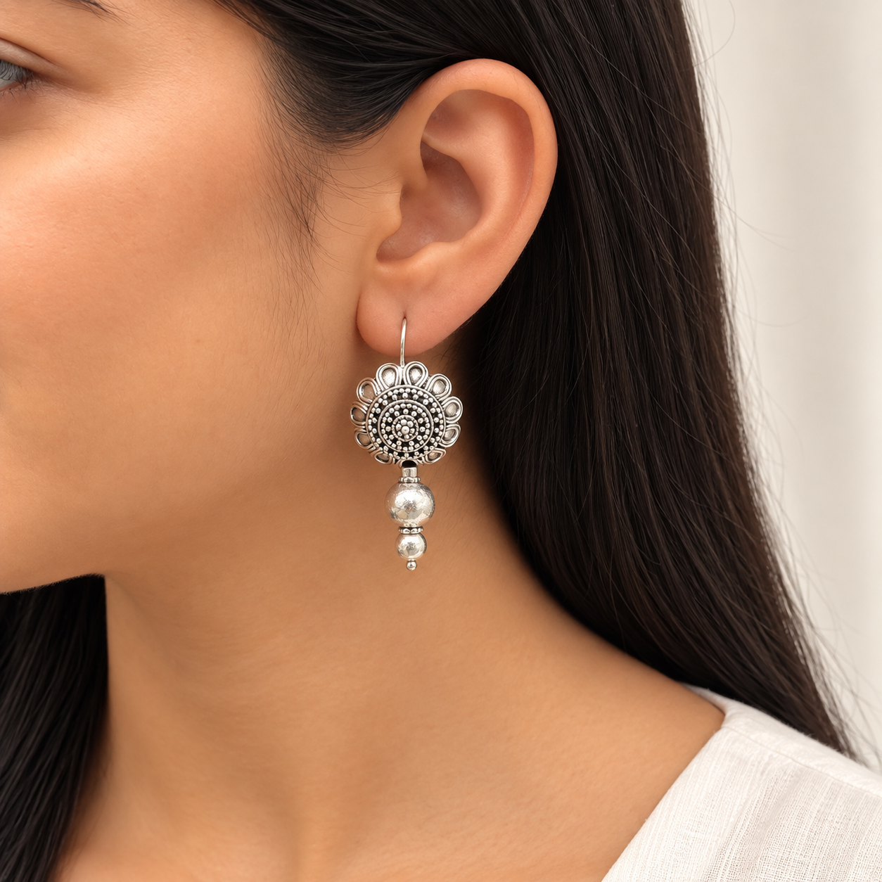 Model wearing oxidised 925 silver flower bead drop earrings