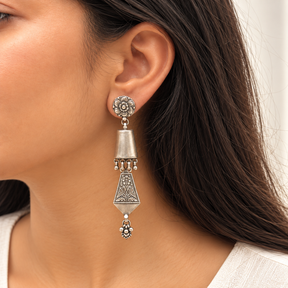 Model wearing oxidised 925 silver bird motif long earrings