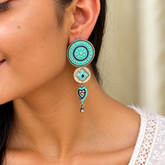 Model wearing 925 silver aqua enamel tiered drop earrings