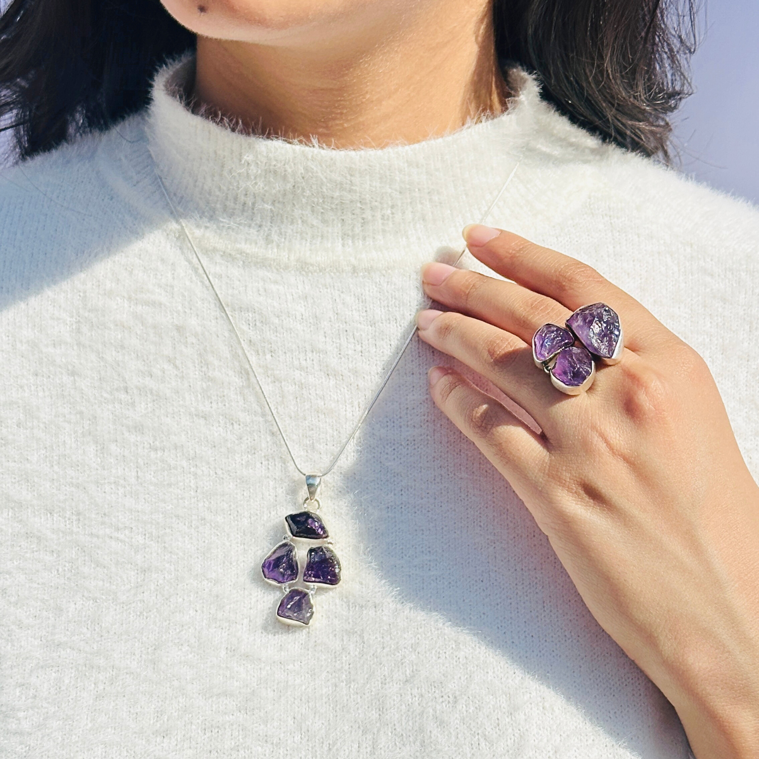 Minimal Pendants
Colorful Pendants
Gemstone Pendant

Amethyst Pendant
Minimal silver pendant
Purple color pendant 
Purple Jewellery
Pendant for women
Gifts for women
Silver pendant 925

Collection of colorful gemstone pendants on a white surface

Person wearing a necklace and two purple rings on a white sweater