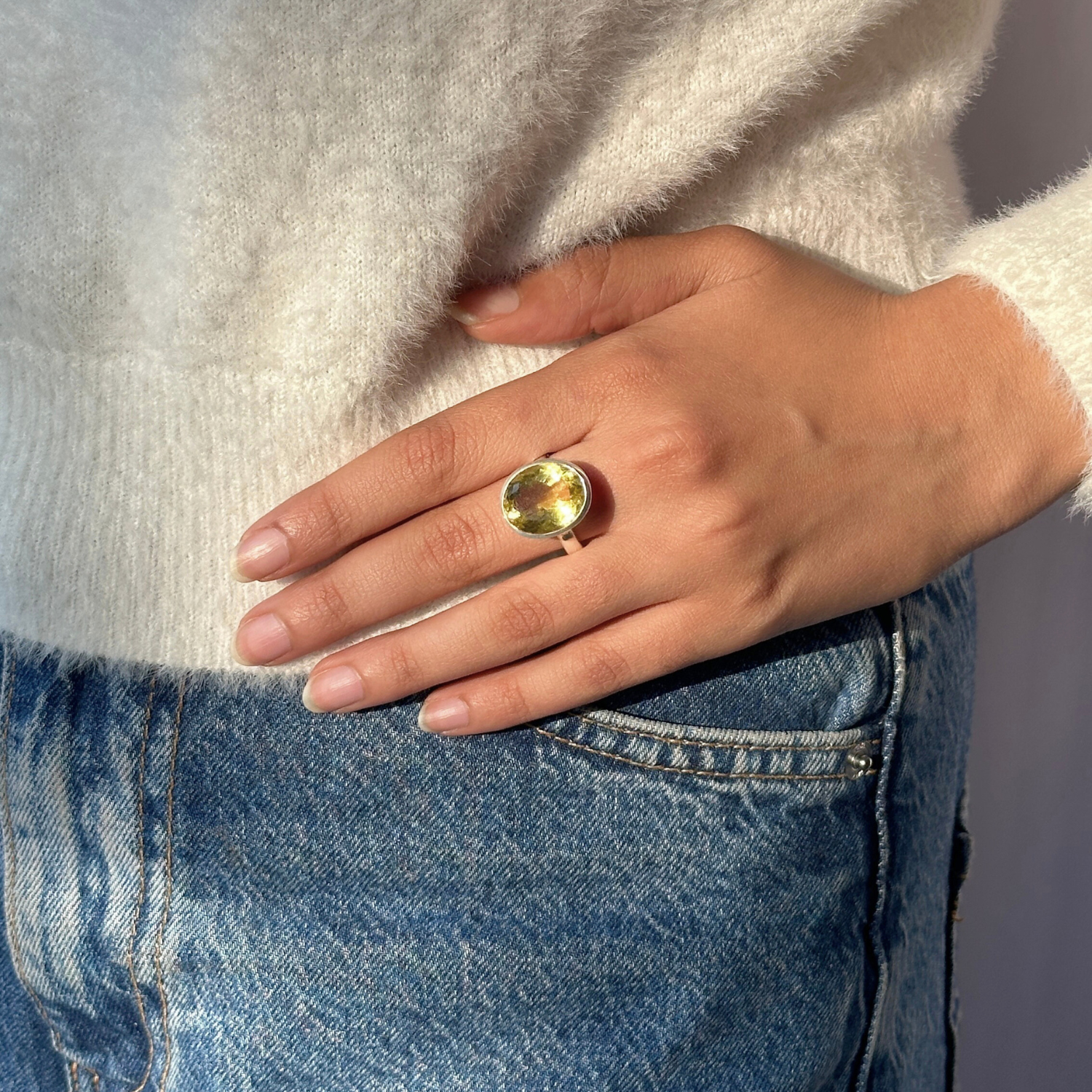 Lemon quartz silver 925 pendant for women

Natural lemon quartz gemstone silver pendant

Soft yellow lemon quartz 925 silver pendant

Lemon quartz stone silver pendant

Minimal pendant 


Hand wearing a gold ring with a large gemstone, wearing a white sweater and blue jeans.
