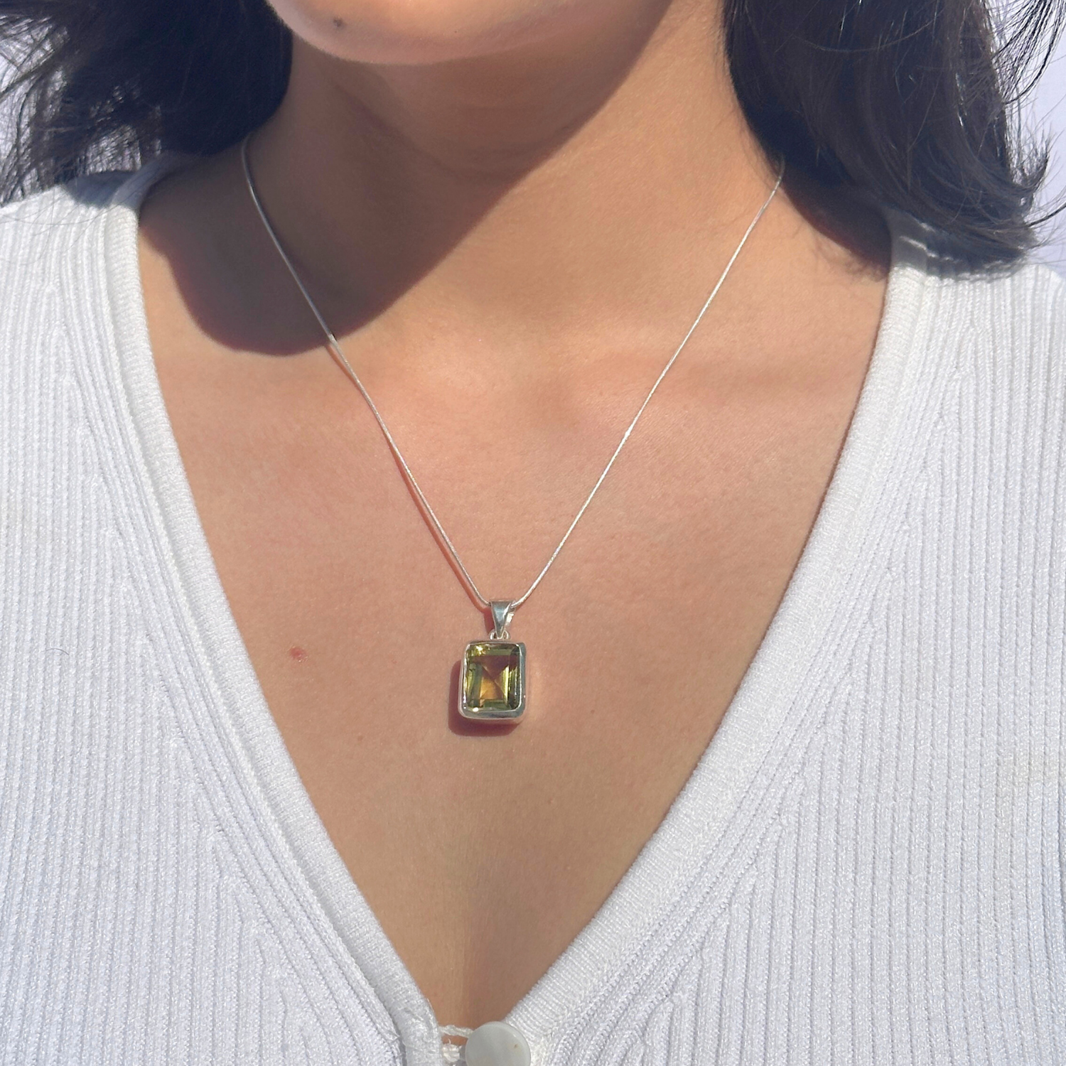 Lemon quartz silver 925 pendant for women

Natural lemon quartz gemstone silver pendant

Soft yellow lemon quartz 925 silver pendant

Lemon quartz stone silver pendant India

Elegant lemon quartz silver pendant online

Necklace with a green gemstone pendant worn by a person in a white top.