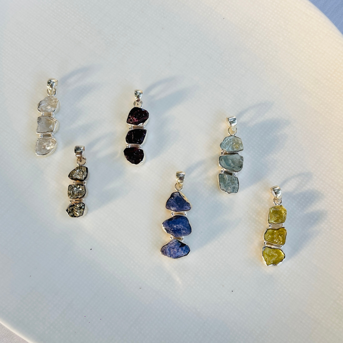 Minimal Pendants
Colorful Pendants
Gemstone Pendant
Peridot Pendant
Aquamarine Pendant
Rainbow Moonstone Pendant
Amethyst Pendant
Gun Metal Pendant
Garnet pendant
Minimal silver pendant
Green pendant
Blue pendant
White pendant
Multicolor pendant
Pendant for women
Gifts for women
Silver pendant 925

Collection of colorful gemstone pendants on a white surface