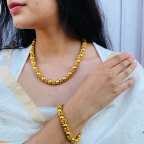 statement gold necklace intricate craftsmanship close up