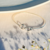 Silver 925 cuff bangle for women

Sterling silver 925 open cuff bangle

Minimal silver 925 cuff bracelet

Minimal 

minimal silver 

bracelet 

Silver infinity bracelet on a textured surface with a blurred natural background