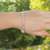 Model wearing rose quartz cabochon bezel-set sterling silver curb chain bangle