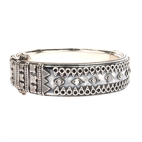 Thick oxidised silver bangle with tribal embossed motifs